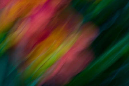 Abstract blur created by moving camera while shutter was open, creating graceful, diagonal lines of orange, yellow, blue, green, and magentaの写真素材