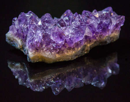 Natural untreated druse of amethyst crystals on a black backgroundの写真素材