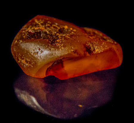 Natural raw amber on a black background closeupの写真素材
