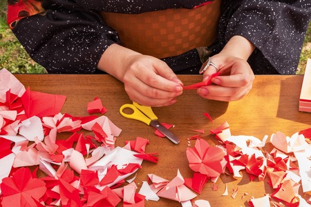 Japanese woman shows a master class on creating origami flowers from paperの写真素材