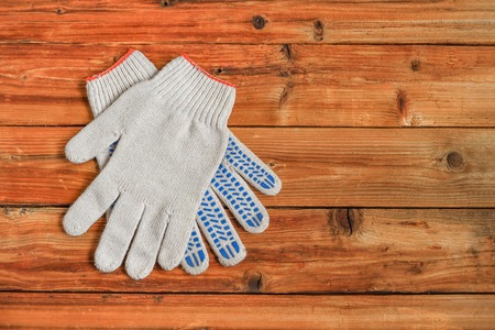 Work gloves on wooden background. Copy space