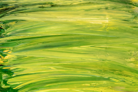 Green and yellow acrylic paint brush strokes texture backgroundの写真素材