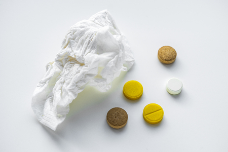 Handkerchief and pills on the white table. The concept of coldsの写真素材