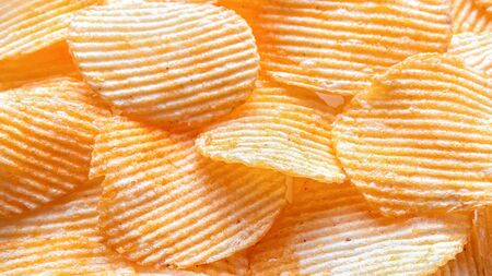 Background of corrugated potato chips with lobster