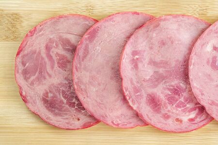Slices of sliced ham on the kitchen Board close-up