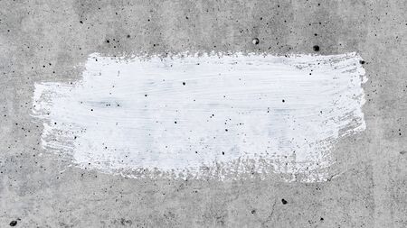 A smear of white paint on a gray wall. Wall background space for your textの写真素材