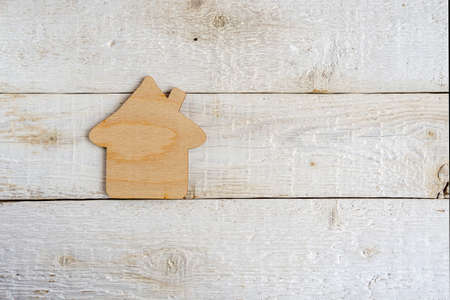 Toy house, on a wooden background. Housing and real estate concept.の写真素材