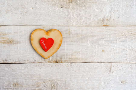 Two hearts, red and wooden on an old white background. Text I love you. Valentine dayの写真素材