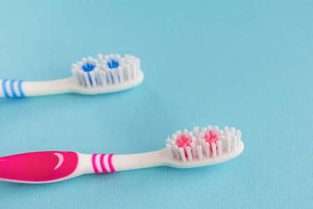 Two new toothbrushes on a blue background.の写真素材
