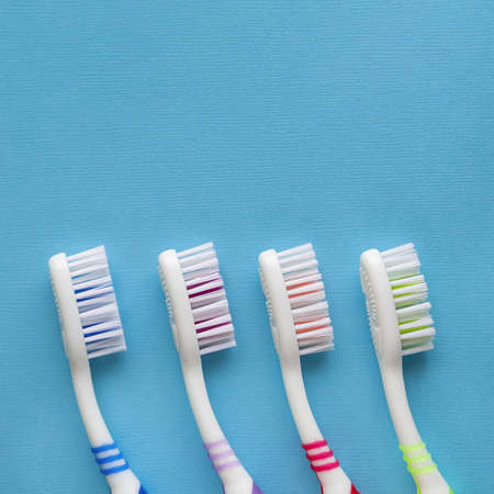 Toothbrushes on blue background. Top view