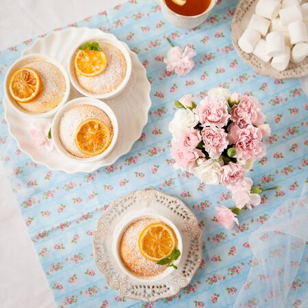 Lemon pudding cake decorated with green mint leaves and caramelised lemon sliceの写真素材