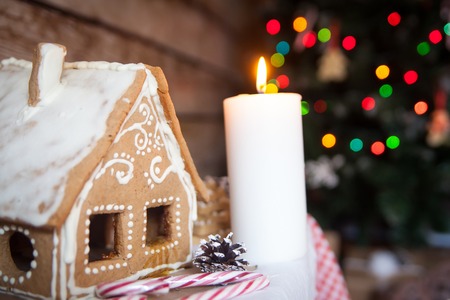 Christmas decor: gingerbread house, new year candleの写真素材