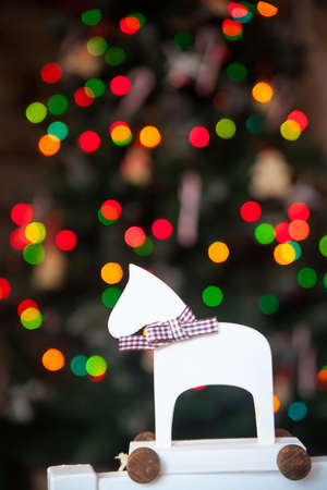 Christmas decor: white wood horse, colored bokehの写真素材