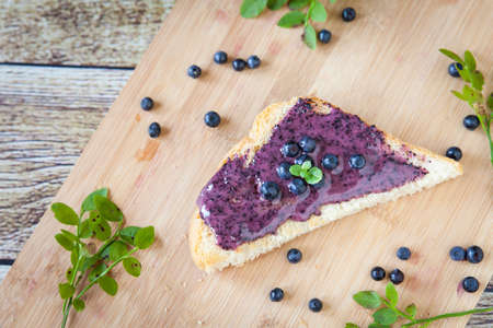 Healthy breakfast. Bread with cream honey and blueberries