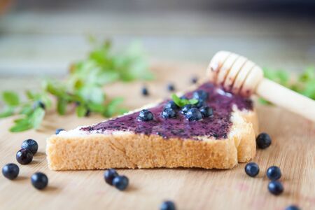 Healthy breakfast. Bread with cream honey and blueberriesの写真素材