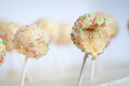 Homemade cake pops with sprinkles. Bitten cake-popsの写真素材