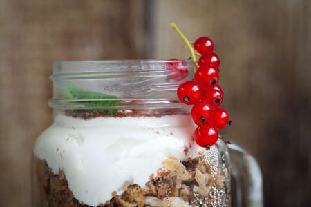 Healthy breakfast in a glass mason jar. Fresh red currants. Close-upの写真素材
