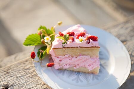 Delicate cake with strawberry on concrete stairsの写真素材
