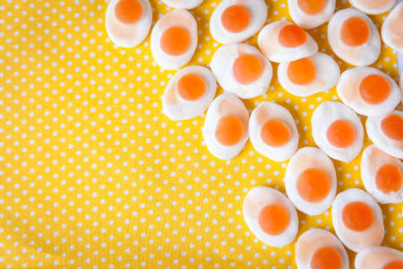 Jelly omelette candies on a yellow polka dot textile