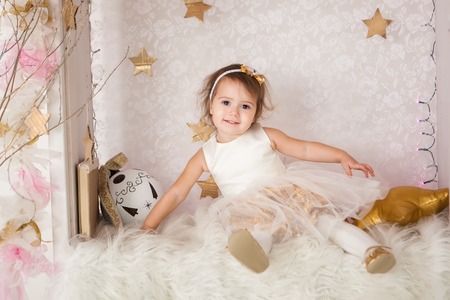 Cute smiling girl with a big Christmas ball. Christmas timeの写真素材