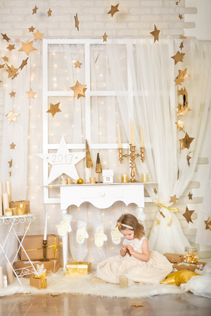 Cute smiling girl with gold stars. Christmas timeの写真素材