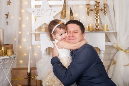 Cute girl hugs her father. Christmas timeの写真素材