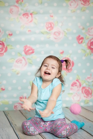 Emotional little girl playing with her knitted toys.の写真素材