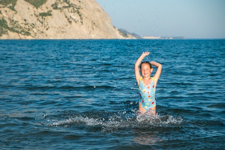 Cute girl having fun on a beachの写真素材