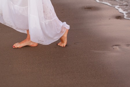Woman's legs on a beach in the evening. Zakynthos, Greece. Ionic Seaの写真素材
