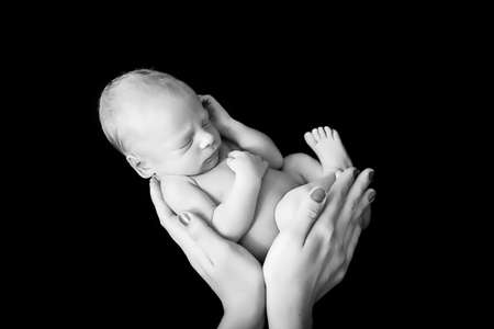Newborn baby in mothers hands