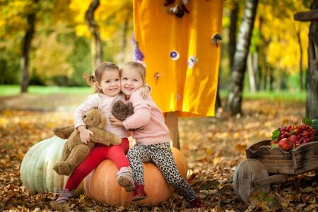 Smiling girls in the autumn parkの写真素材