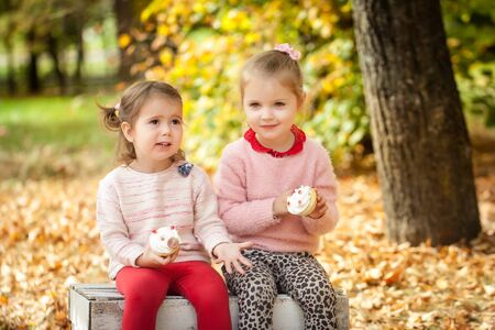 Smiling girls in the autumn parkの写真素材