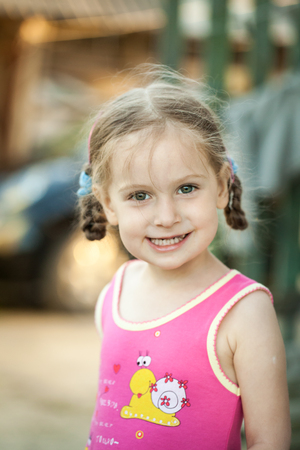 Small happy girl on a farm in springの写真素材