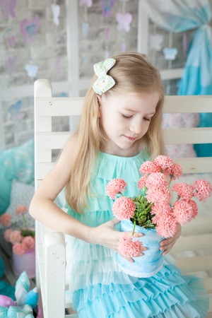 Cute girl in a gentle pastel spring decorの写真素材