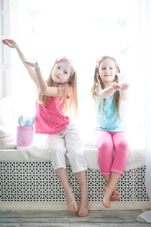 Cute girl in a gentle pastel spring decor. Very lightの写真素材