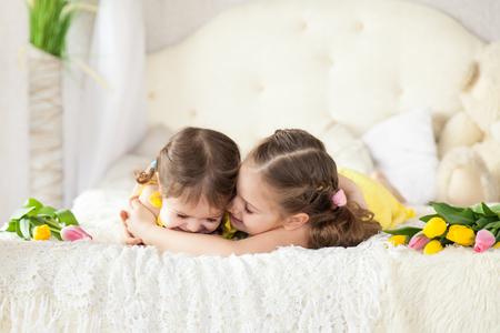 Cute sisters in a light spring studioの写真素材