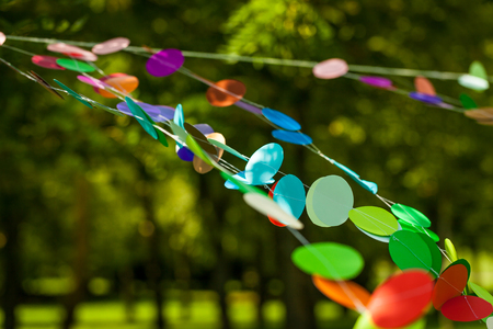 Paper circle colorful garland. Rainbow vibrant decor for birthday or wedding summer partyの写真素材