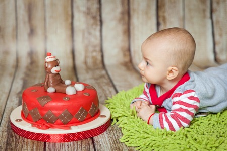 Mini birthday with sock monkey theme. Cute 6 months baby boy in a monkey costume with a sweet party...