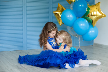 Birthday party in blue and gold collors. Studio session. Fashion girl celebrating her birthdayの写真素材