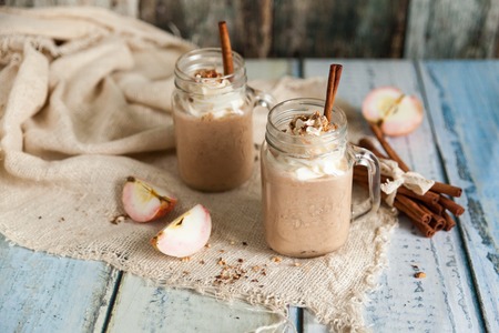 Healthy smoothie Apple Pie with nuts, whipped cream and autumn spices in mason jars. Seasonal autumn drinkの写真素材