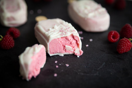 Raspberry Cheesecake or mousse dessert with pink sugar sprinkles in the form of ice cream covered...