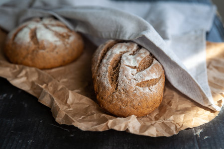 Homemade rye bread on a kraft paper with a linen napkin