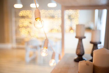 Vintage garland with old style light bulb. Christmas white interior on backgroundの写真素材