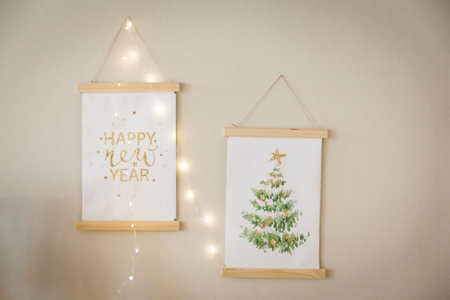 Home interior posters mock up with wooden frames on the wall, Happy New Year greeting and Decorated Christmas tree paintingの写真素材
