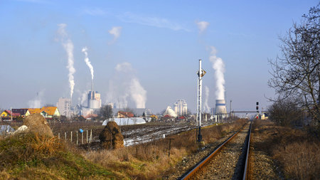 Industrial landscape with power plant and smoke from chimneys in winter.の写真素材