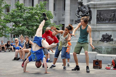 Montreal CANADA - July 16, 2013: 4 young breakdancers on Place d'Armes in front of the Maisonneuve...