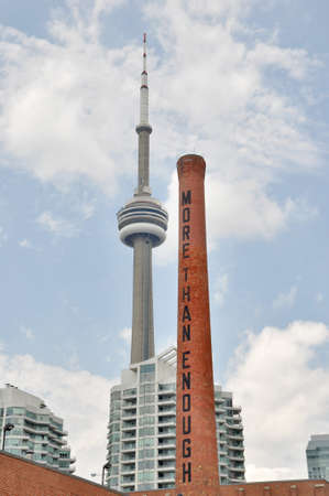 Tornoto, USA - July 10, 2013: View of CN Tower and the chimney of The Power Plant Contemporary Art Gallery at Toronto Harbour front.のeditorial素材