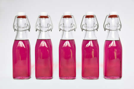 Homemade lavender syrup in glass bottlesの写真素材