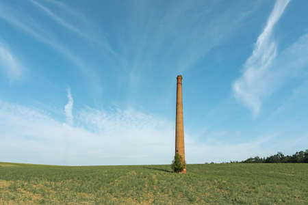 abandoned historic free standing chimney in a fieldの写真素材