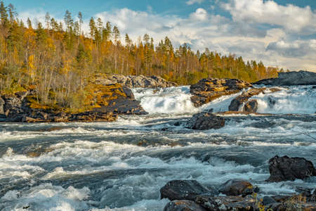 MÃ¥lselvfossen waterfall in Norway in warm autumn colors